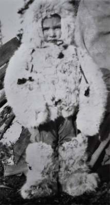 Young child wearing the traditional rabbit fur coat