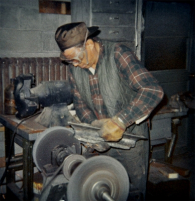 Cree man using an electric sanding stone