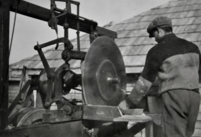 Man operating a mechanical saw