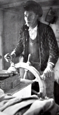 Cree man steering a vessel