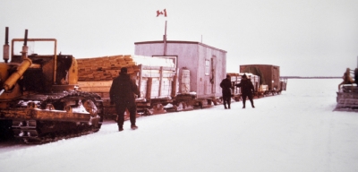 Winter tractor train stopped on the river ice