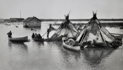 Two teepees are surrounded by water during Spring