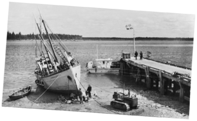 Sailboat or schooner being pulled ashore