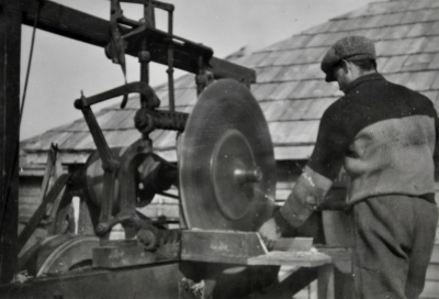 Man operating a mechanical saw 
