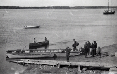 Men loading and boarding a barge