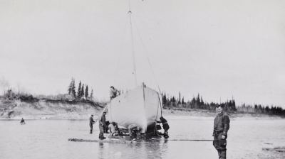 Workers moving a schooner to shore