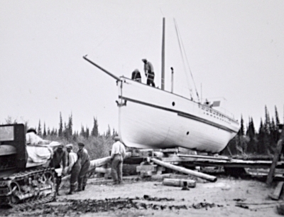Men moving a schooner out of the water