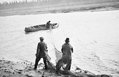 Cree men setting a fish net